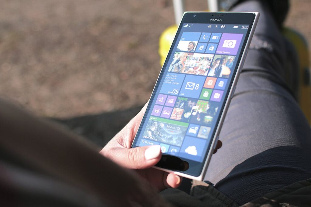 A person navigating through the apps on their smartphone. 