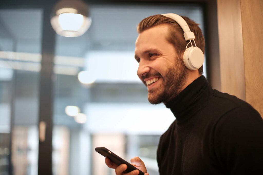 A smiling man wearing headphones. 