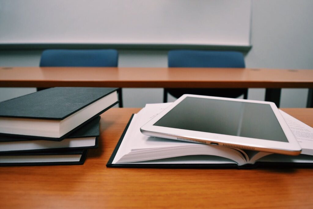 A tablet placed on top of some books.