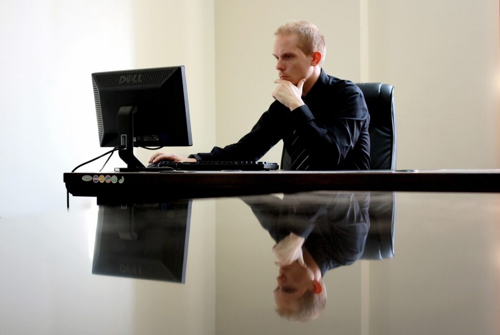 A businessman deep in thought at his desk. 